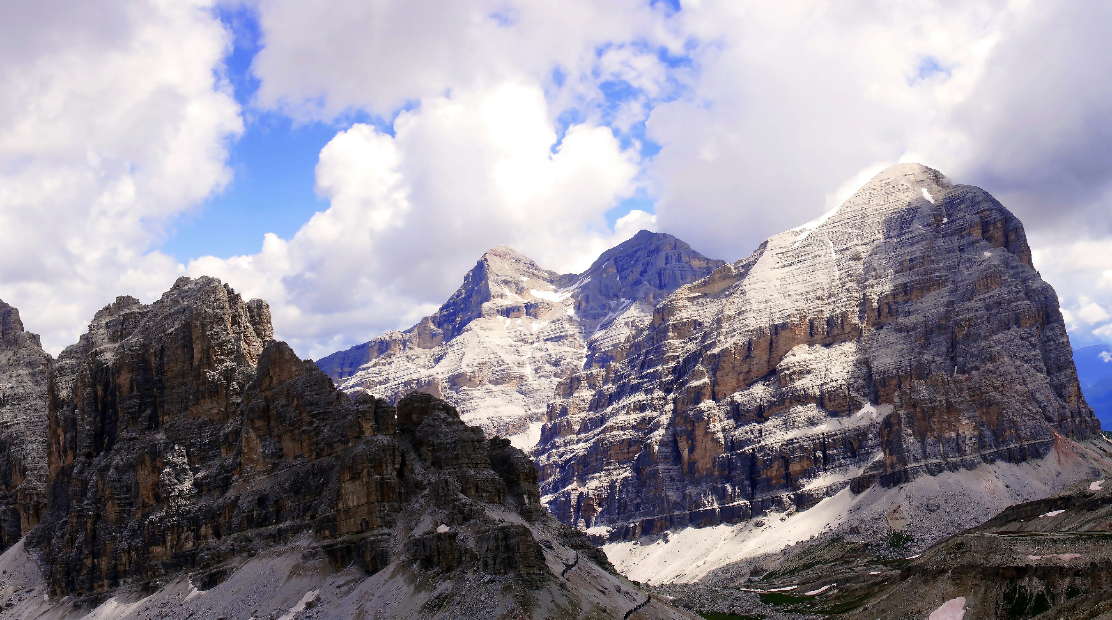 brown rocky mountains under white clouds